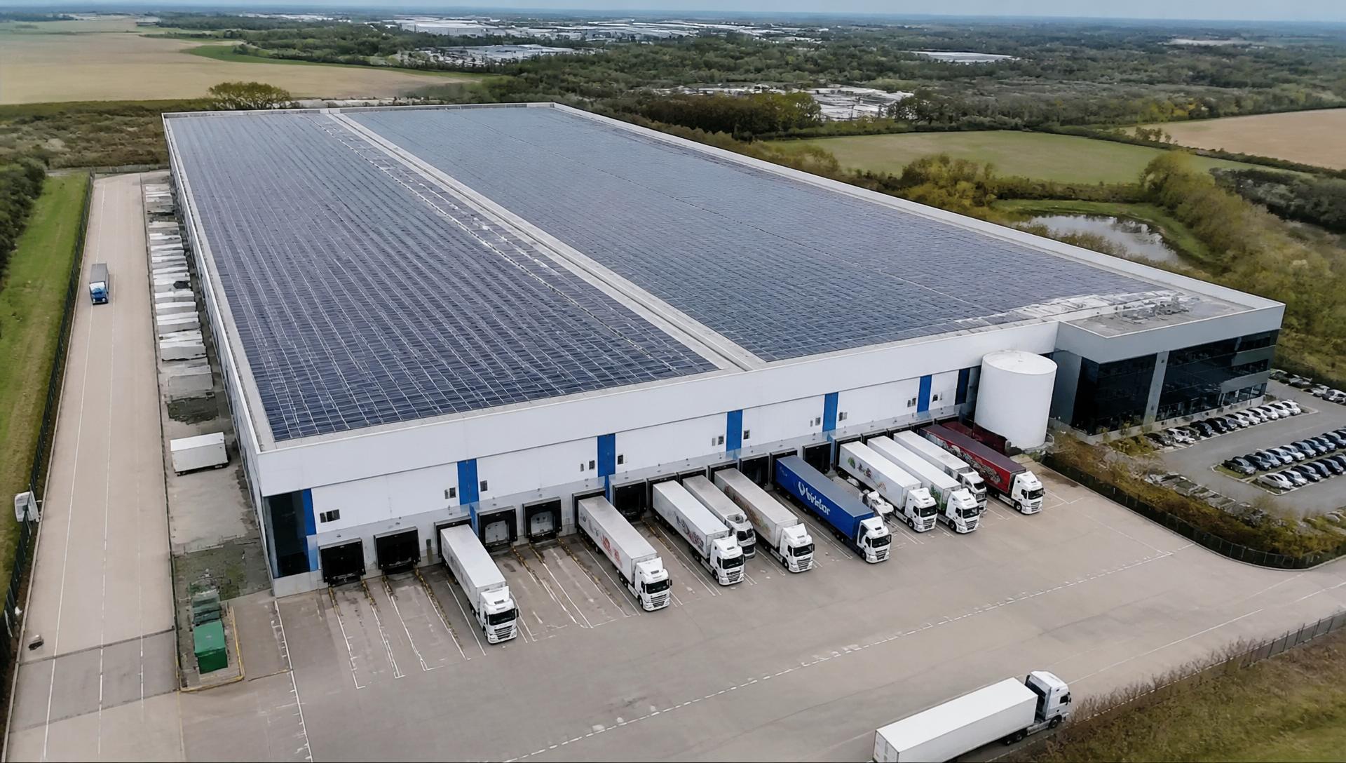 Aerial view of a UK cold storage distribution warehouse with a full solar rooftop